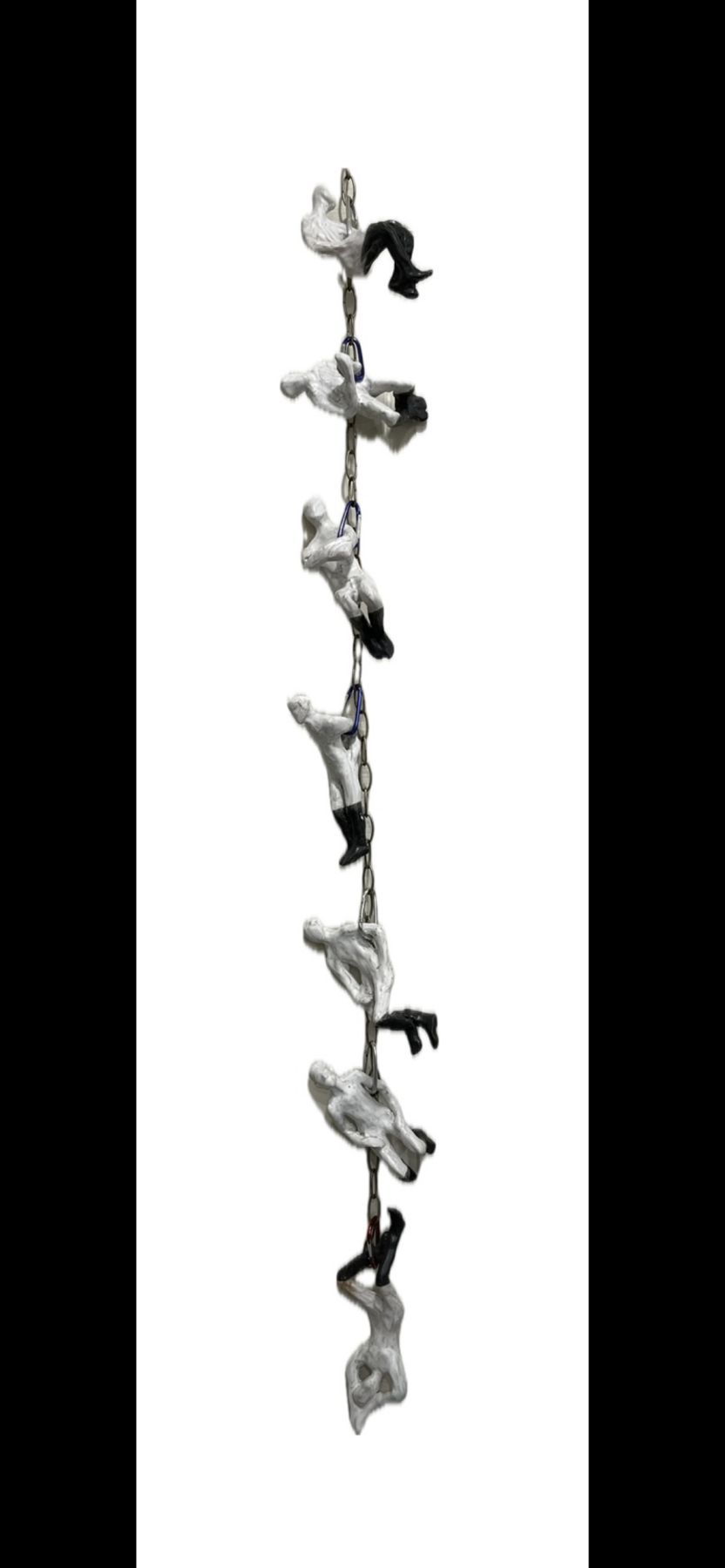 This series of hanging sculptures are on a chain showing emotional physical emotions