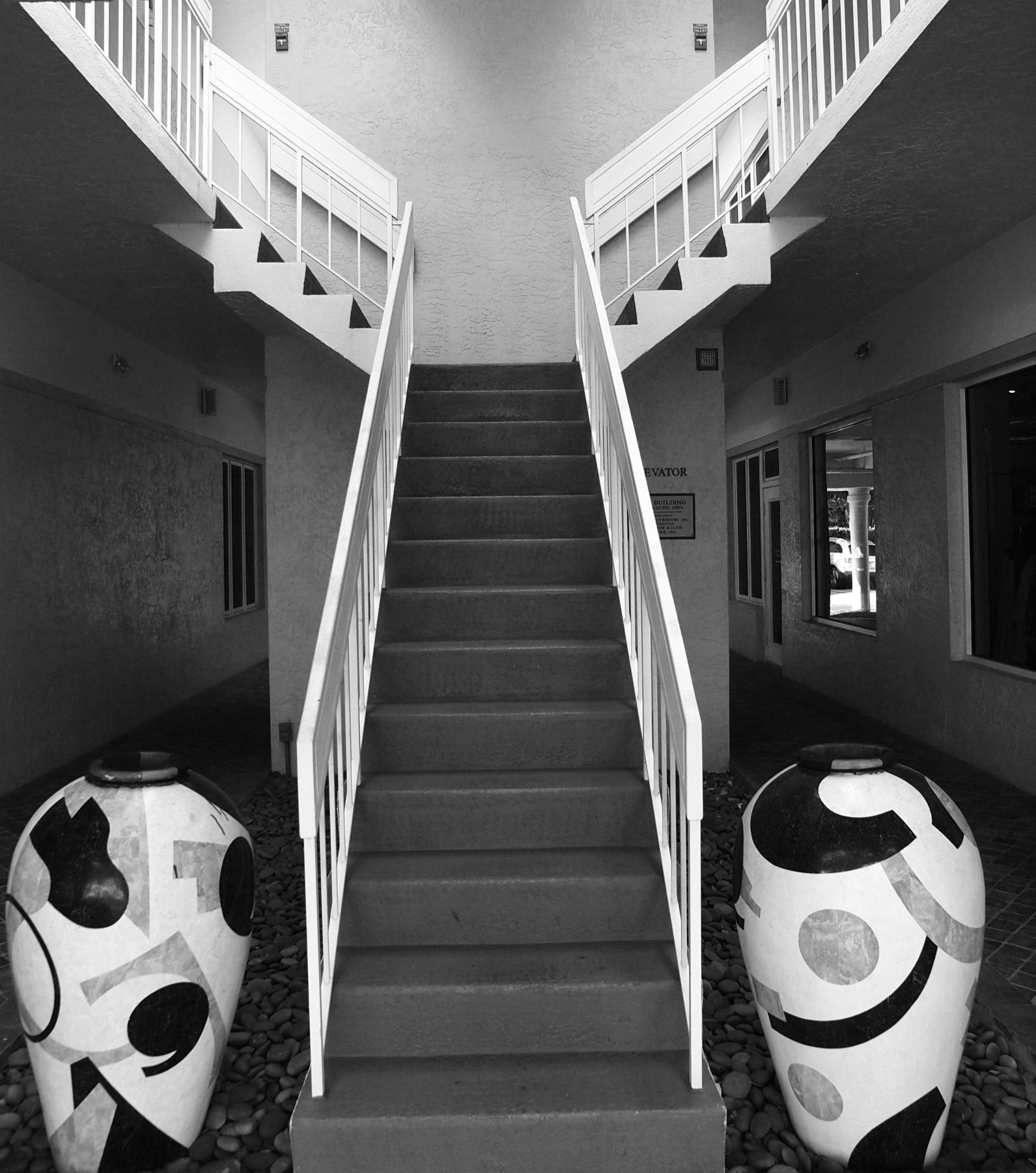 Stairway in Naples Florida and two large urns