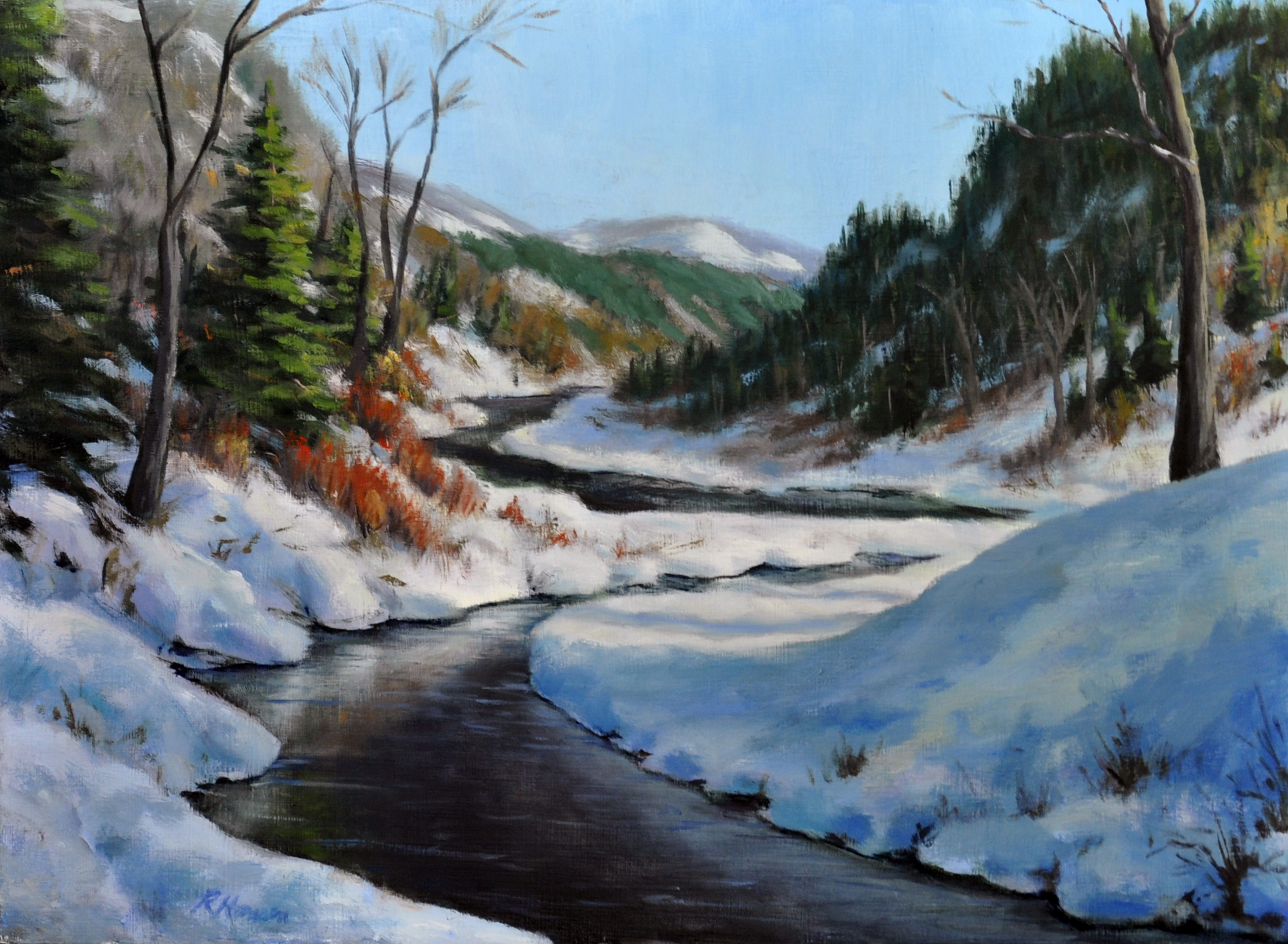 Mountain winter scene with an open water river running though it.