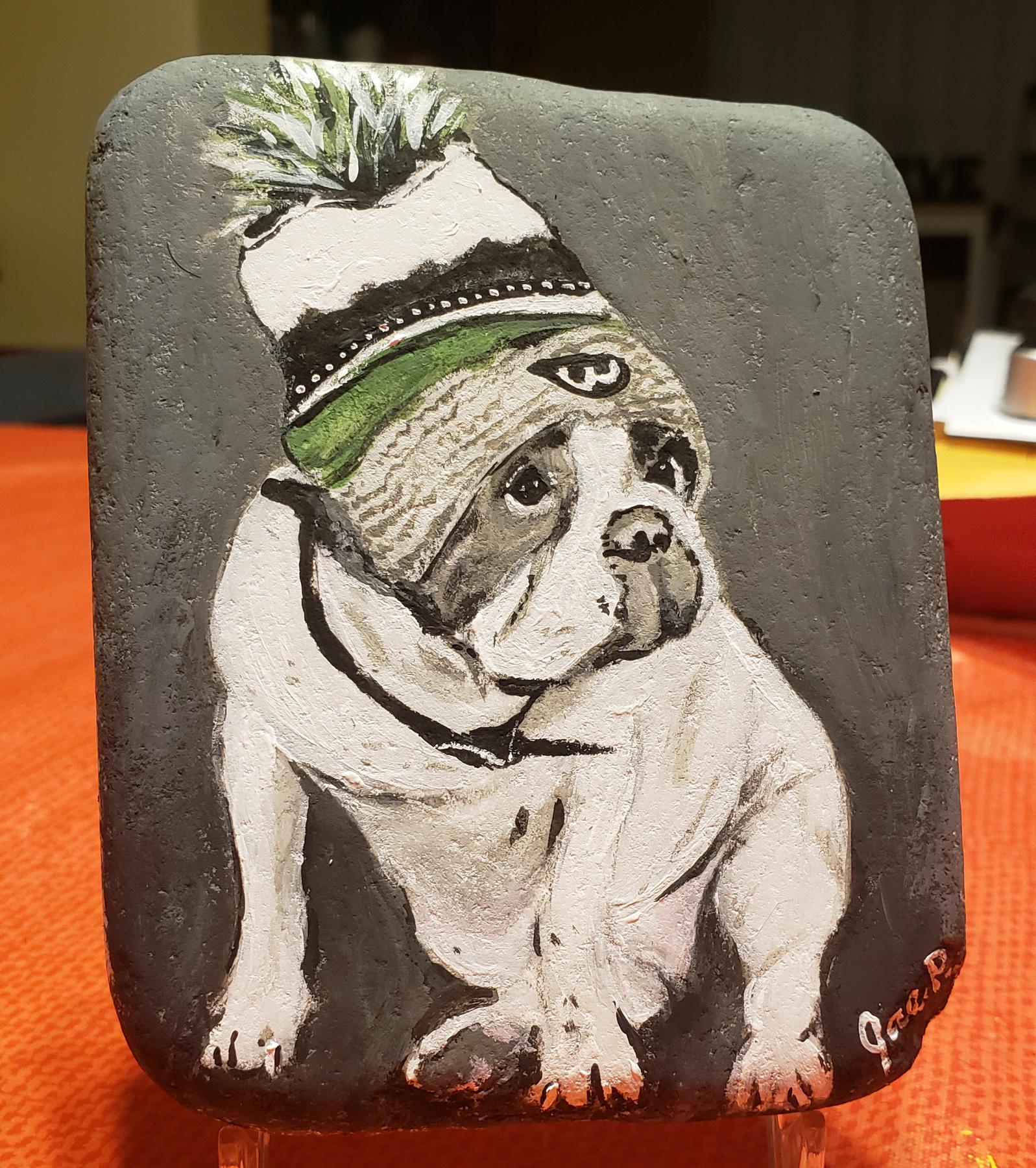 Painting of Donnie Wahlberg's white and grey bulldog that passed, wearing a winter hat.