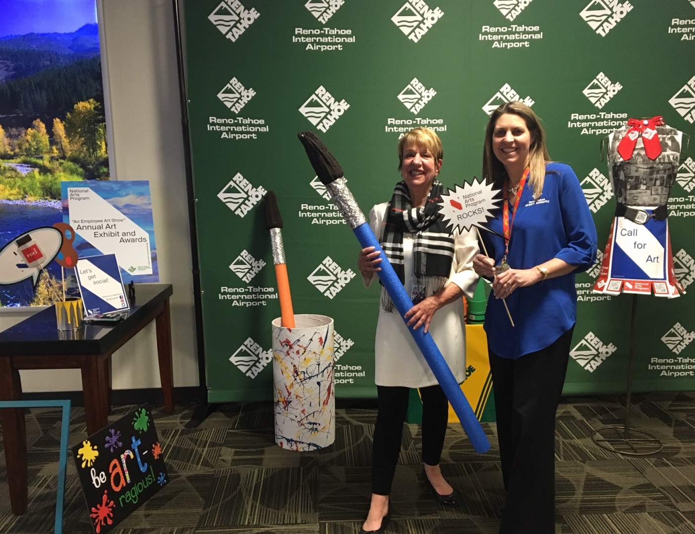 11th Annual Exhibit At the awards reception, coordinator Mary Lee Mansfield and former coordinator Kim Matthews smile at the selfie station.