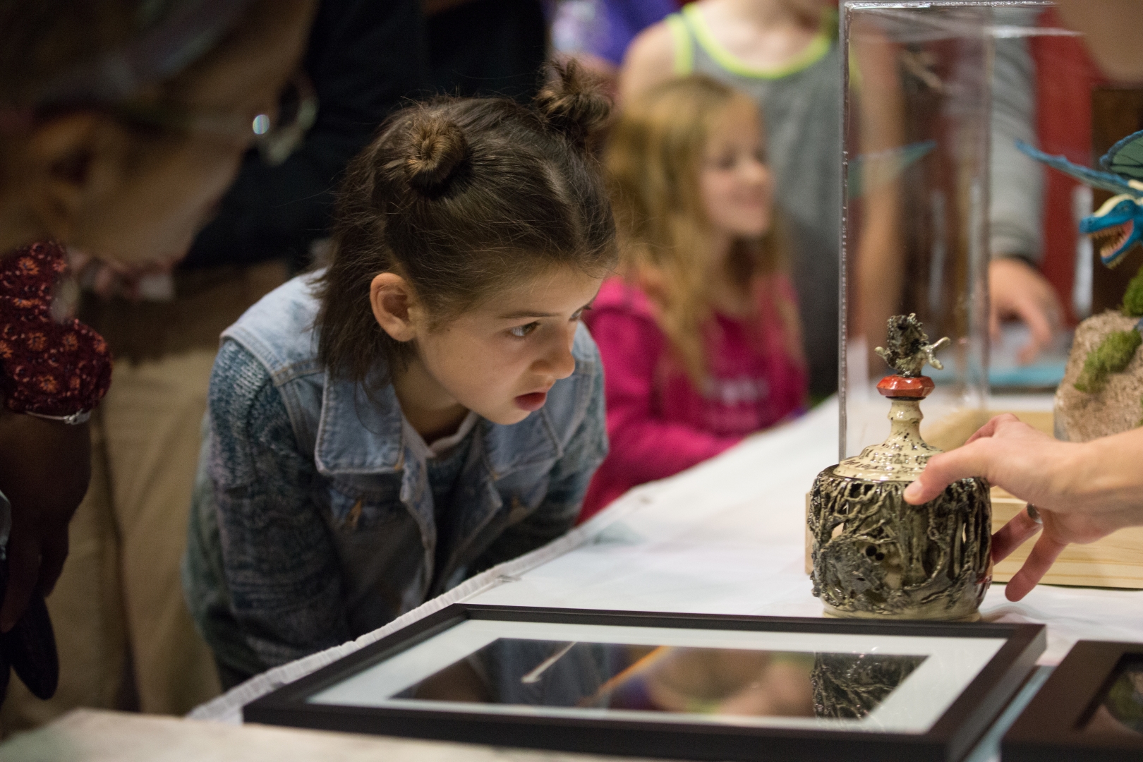 10th Annual Exhibit A youth attendee taking a closer look at the details of the Best of Show winning piece.