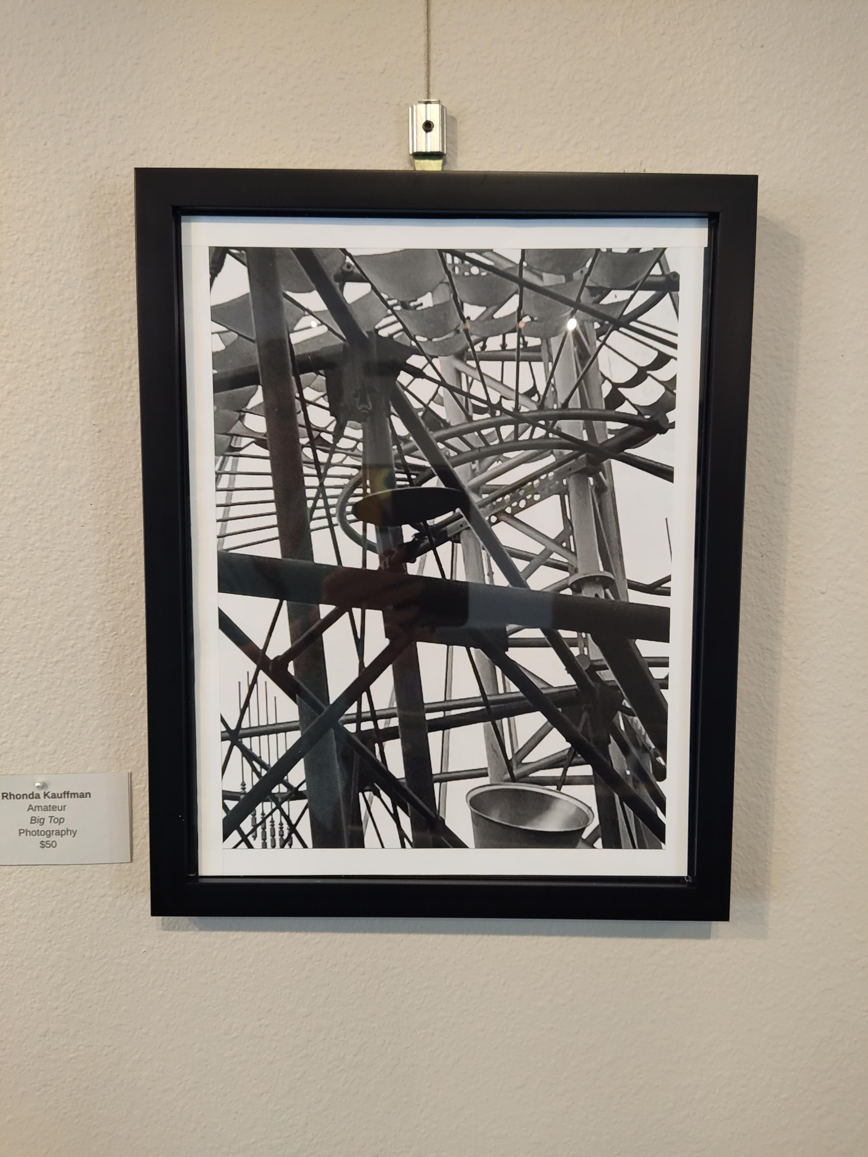 black and white photograph of the inside framing of a large tent