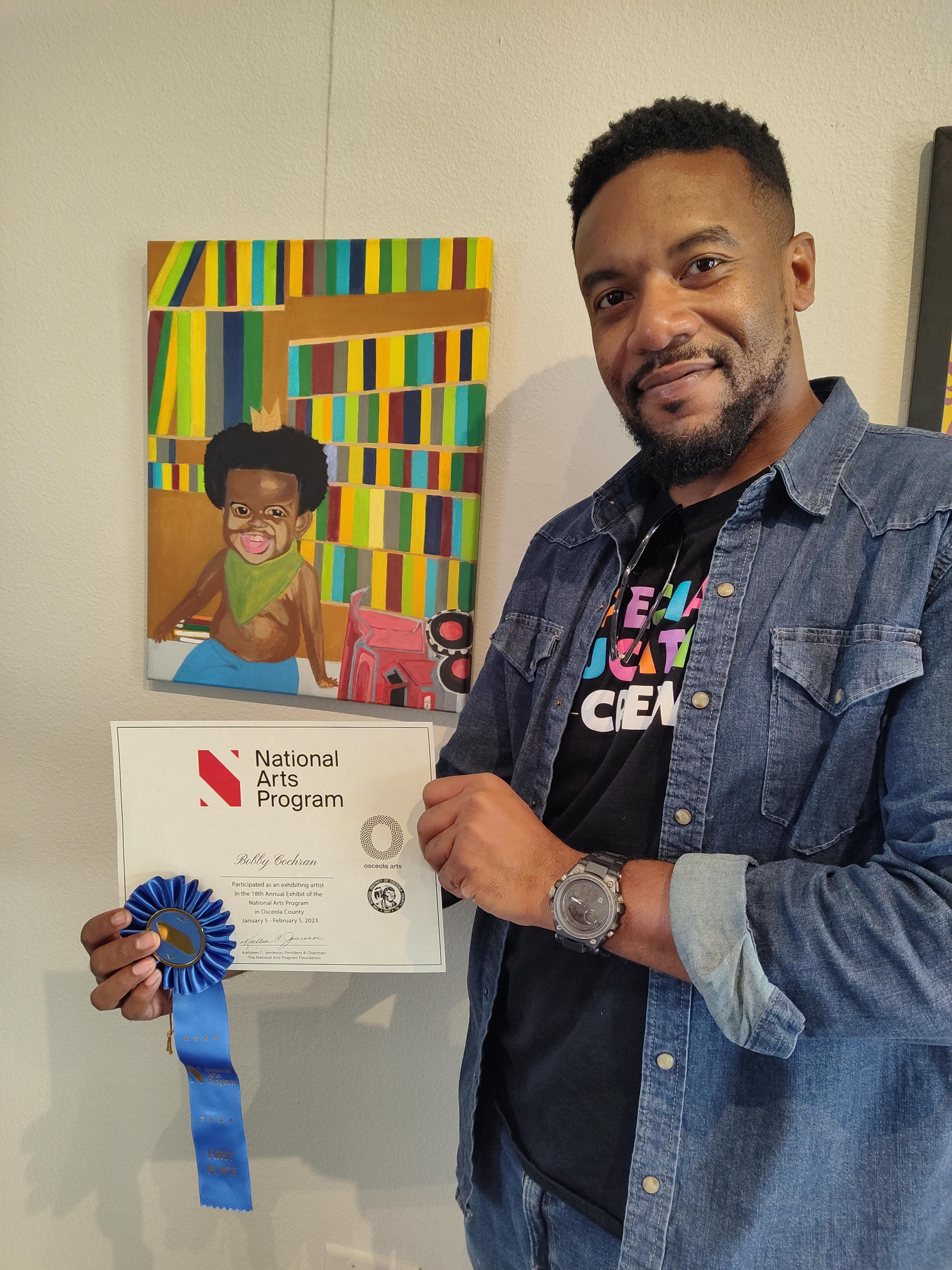 small boy in a crown sitting in front of a colorful backdrop