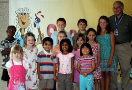 4th Annual Exhibit Steve Gardner, Executive Director of the Greater Orlando Aviation Authority and the participating artists in the Youth Under 12 category.