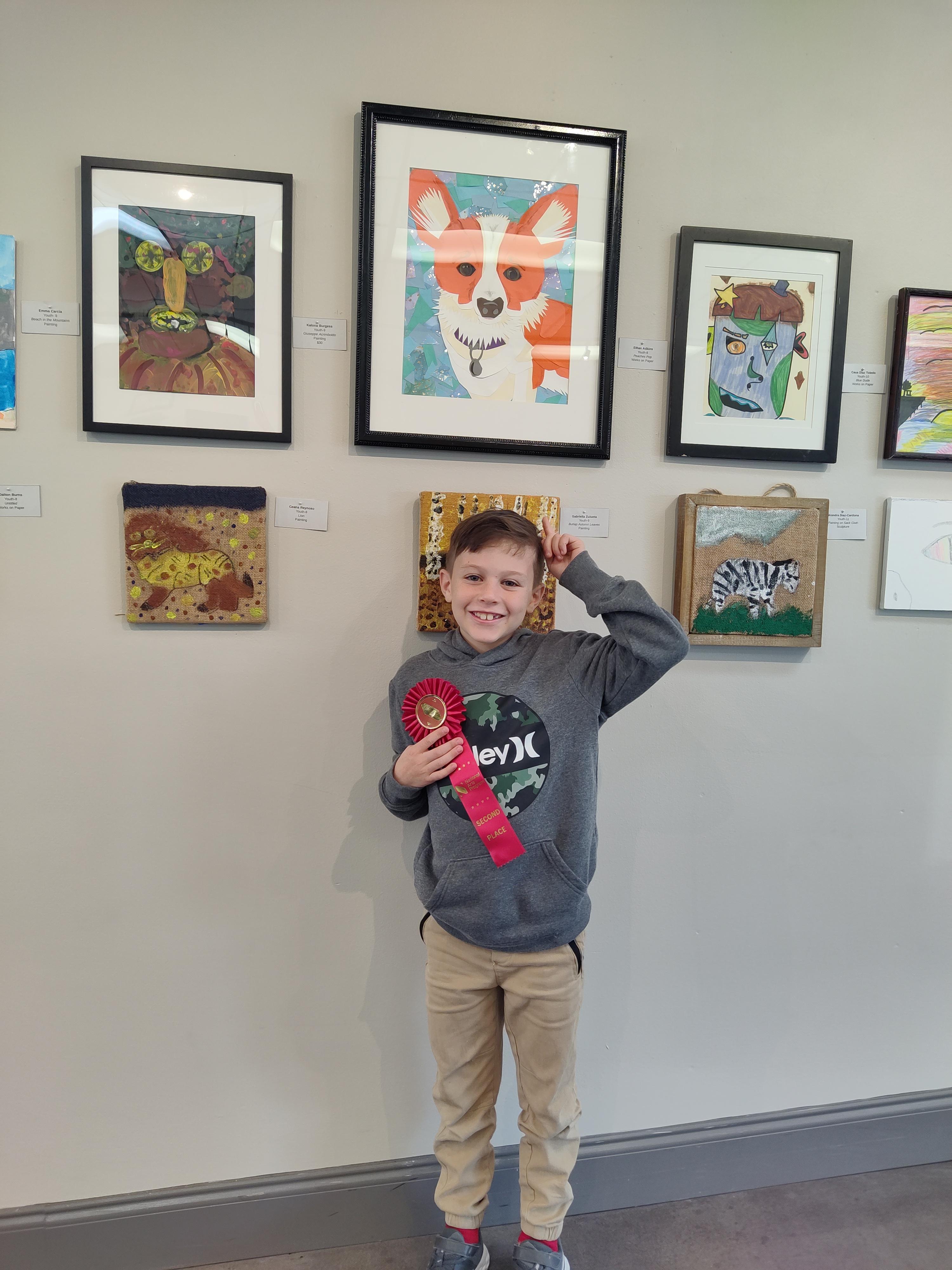 Colorful paper collage portrait of a dog with a collar on and blue background