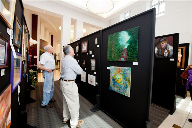 7th Annual Exhibit Attendees to the 6th Annual NAP Exhibition at Atlantic Health Systems, NJ taking in some of the artwork made by very talented employees and their family members.