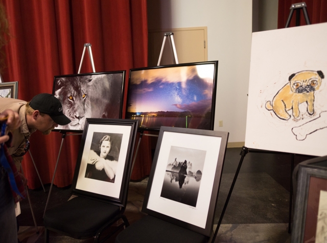 9th Annual Exhibit Reception attendees take a closer look at the award winning artwork at close of event.