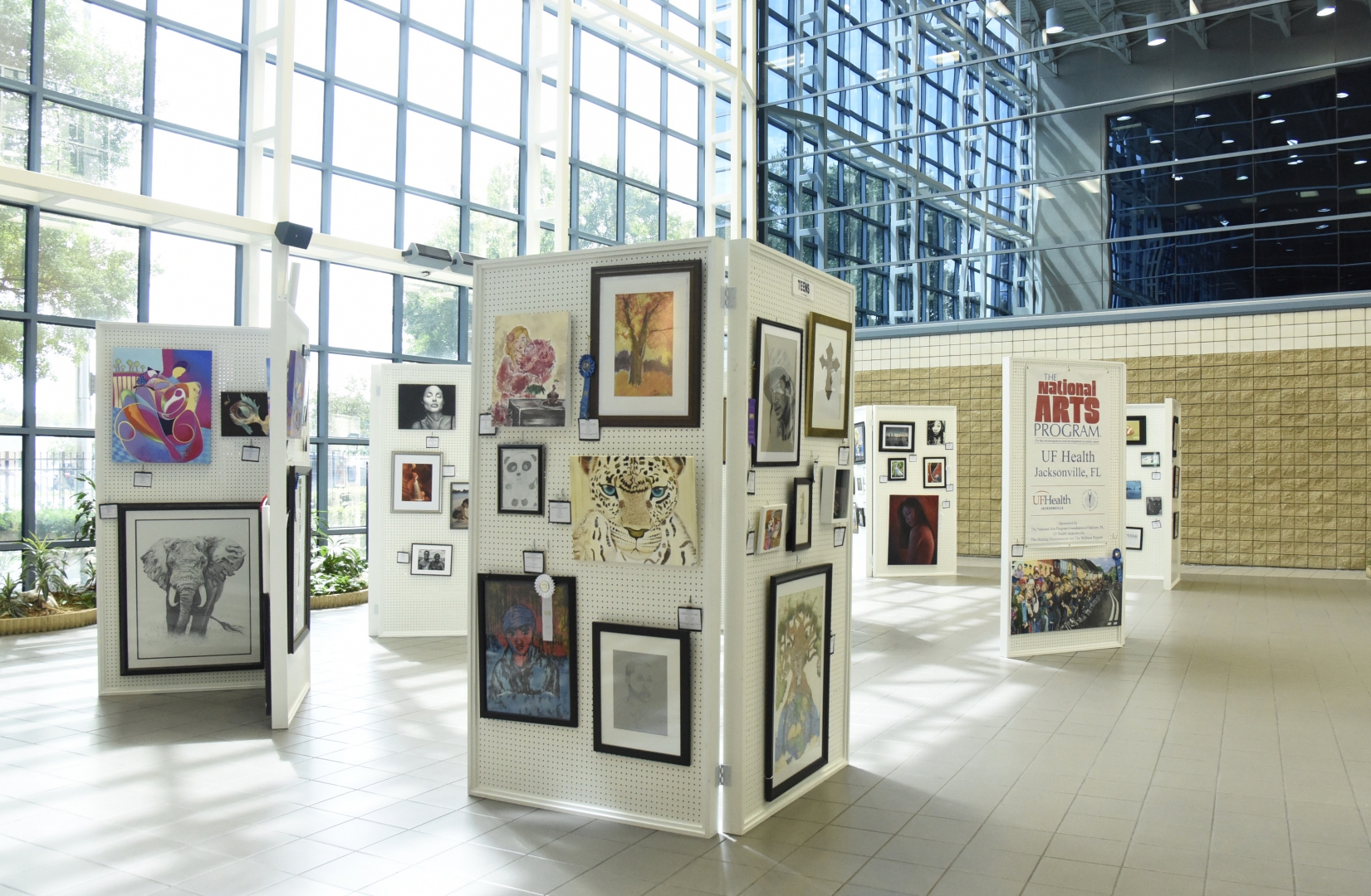 5th Annual Exhibit The Atrium of UF Health Jacksonville filled with vibrant art from this year's show.