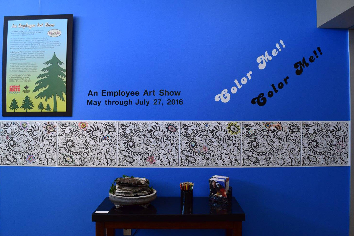 8th Annual Exhibit Coordinator Kim Matthews invited visitors to the exhibition to get involved by including a coloring wall in the gallery.